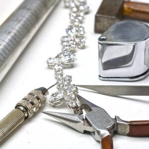 Bracelet with diamond and repairing jewelry tools (loupe,wrench,pliers,hammer)